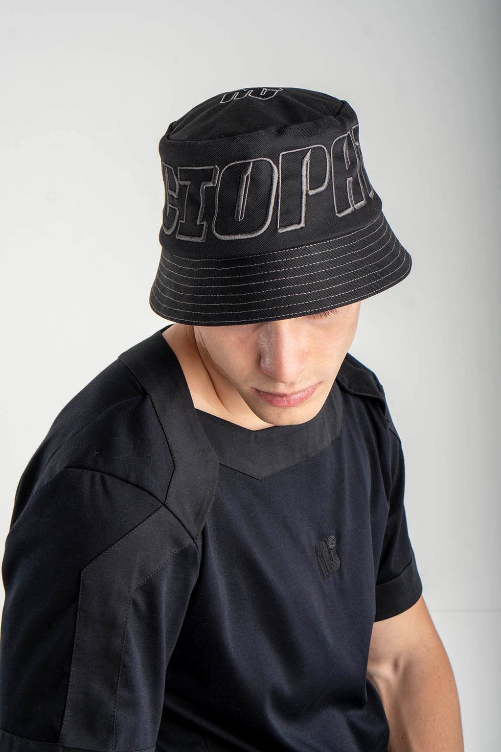 Person wearing a black bucket hat
