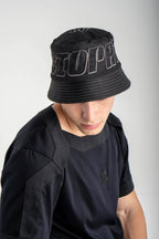 Person wearing a black bucket hat