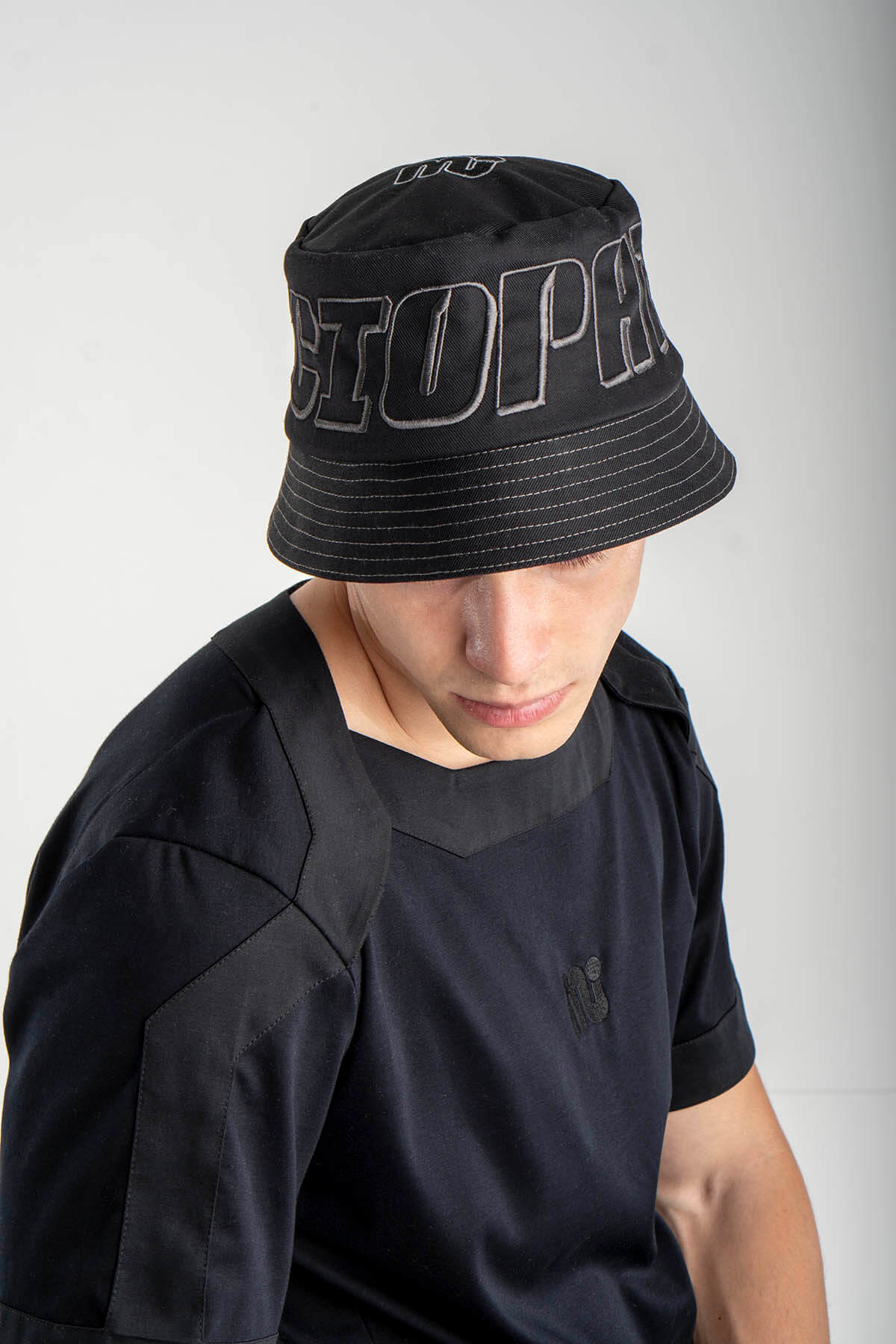 Person wearing a black bucket hat